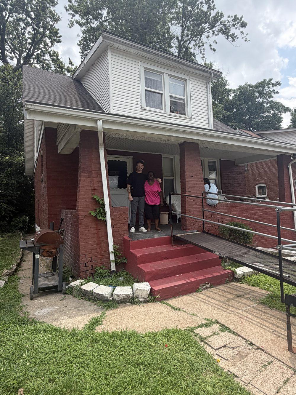 Sam of Brickyard Home Buyers, a St. Louis cash home buyer, with a homeowner on her front porch